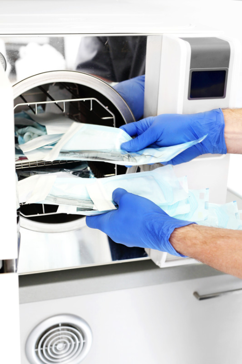Foot care in Dartmouth, Foot Care Nurse placing packaged instruments into an autoclave to be steam sterilized 